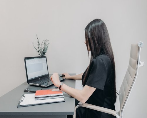 Office worker sitting with good ergonomic posture